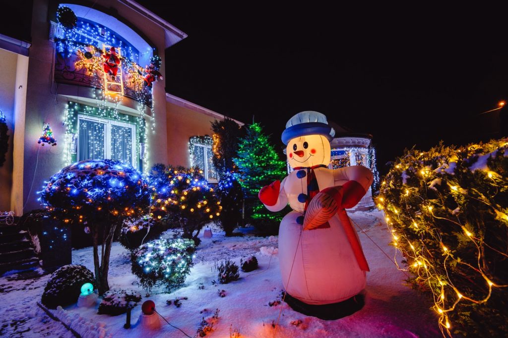 holiday lights and decorations in front yard of house